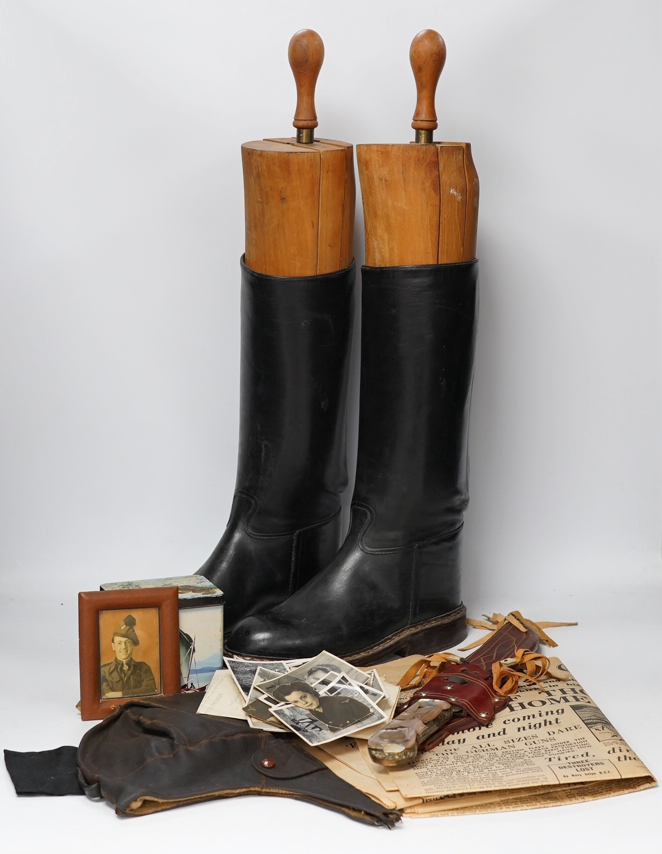 A collection of militaria and WWII related items including; three 1940s copies of the Daily Express with articles related to key events including Dunkirk, a knife in a leather scabbard, a number of photos, an aviation ca